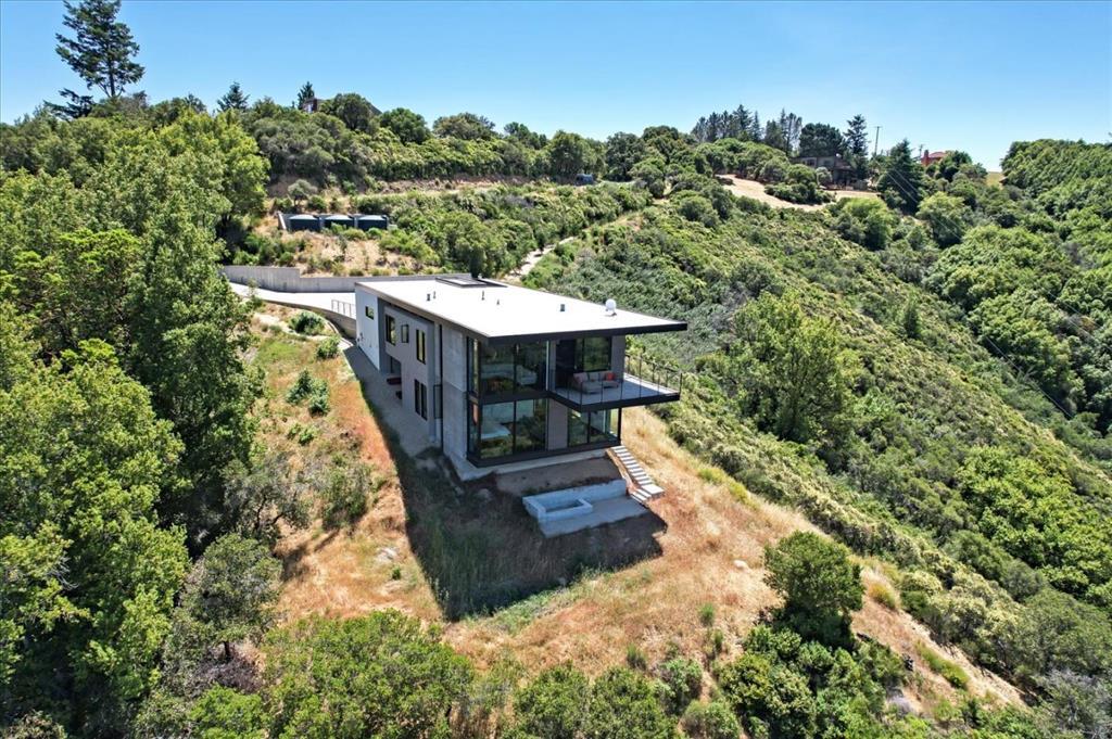 Breathtaking Views! This incredible 3 bed, 2 bath, 2,559 square foot home in the Saratoga hills is ideal for the most discerning buyers. It sits close to the 1,614 acre El Sereno Open Space Preserve with over 7 miles of trails. This unique custom home is almost brand new, finished in 2020 and lightly used as a second home. Huge 13.65 acre lot. This home is full of only the finest materials throughout. The MAFI engineered hardwood flooring, imported from Austria, is the best there is, and adds to the refined beauty of the home. There are Fleetwood floor to ceiling windows and sliding doors all around showing off the amazing views. The home uses radiant heating throughout, Lutron lights and automatic shades, Dornbracht bath fixtures, Toto Neorest smart toilets, Subzero refrigerator, Wolf burners and oven, Cove Dishwasher, and even a Miele coffeemaker . The covered deck has panoramic views and is wonderful place to relax and enjoy the outdoors. Award winning Saratoga schools.