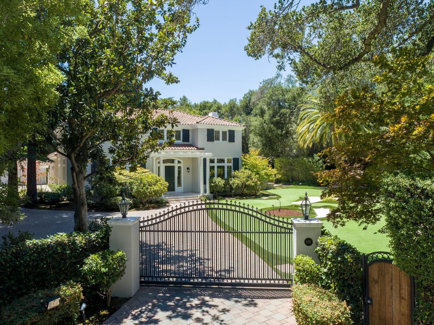 Gated on the edge of the Menlo Circus Club area with timeless architecture, beautifully appointed interiors, and exceptional grounds. Two levels with elegant formal rooms, dedicated office, and extra-large kitchen and family room combo. 5 bedrooms, each with en suite bath, including one on the main level plus upstairs primary suite with sumptuous bath with heated floors and private office or fitness center. Exceptional grounds for fitness, recreation, and entertaining with solar-heated pool and spa, 9-hole putting green with bunkers, batting cage, sport court, plus fireplace and barbecue terraces, all in a very private setting dotted with many fruit trees. Excellent Menlo Park schools.
