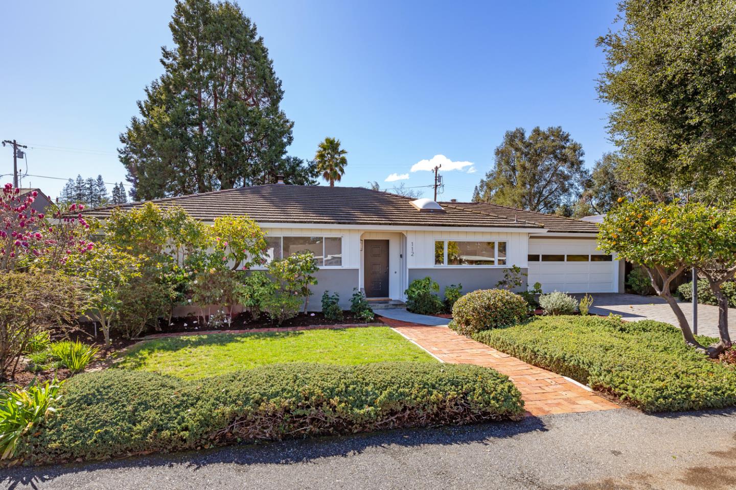 Exuding classic charm, this single-level home sits on a large 10,000 square foot lot in the heart of premier North Los Altos. The favorable floor plan has a large living/dining room overlooking the backyard, a lovely sunroom or home office with tall windows, a comfortable family room, and an eat-in kitchen. Throughout the home, you'll find gorgeous hardwood floors, a fresh color palette, and expansive windows revealing views of the lush grounds. The bedrooms are located on one side of the home with wide windows, and the primary suite offers outdoor access, two closets, and abundant natural light. The large backyard is ideal for entertaining and gardening, complete with raised beds, gorgeous shade and fruit trees, mature landscaping, level lawn, garden sitting areas, and a large partially covered patio. All of this, less than a mile from Los Altos and with access to top-rated Los Altos schools.