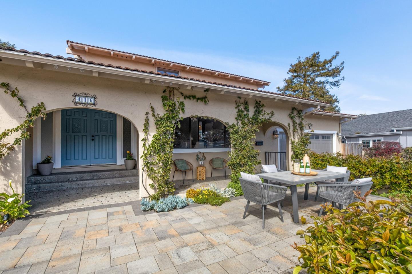 Just seven blocks to the beautiful Monterey Bay, this Pacific Grove Mediterranean coastal home is comprised of more than 2,200+ sq ft. The 1,662 sq ft ground-level features a comfortable living room made cozy by the grand fireplace, a formal dining room, and a recently updated kitchen with sit-up counter that joins with the family room. Additionally, the main level has a large ensuite bedroom with sliding doors to the private paver-covered backyard. Upstairs with a peak of the ocean, is an oversized ensuite bedroom with two closets and enough space for a sitting area spread across 581 sq ft (once two bedrooms, made into one). A 500+ sq ft two-car garage with JuiceBox EV charger, laundry area and workspace with a sliding door allows for natural light. Extending the house is the east-facing patio that warms up on sunny mornings. A large home ready to move into, it's an easy seven block stroll to Robert Down School and just a few more to restaurants and shopping of downtown Pacific Grove.
