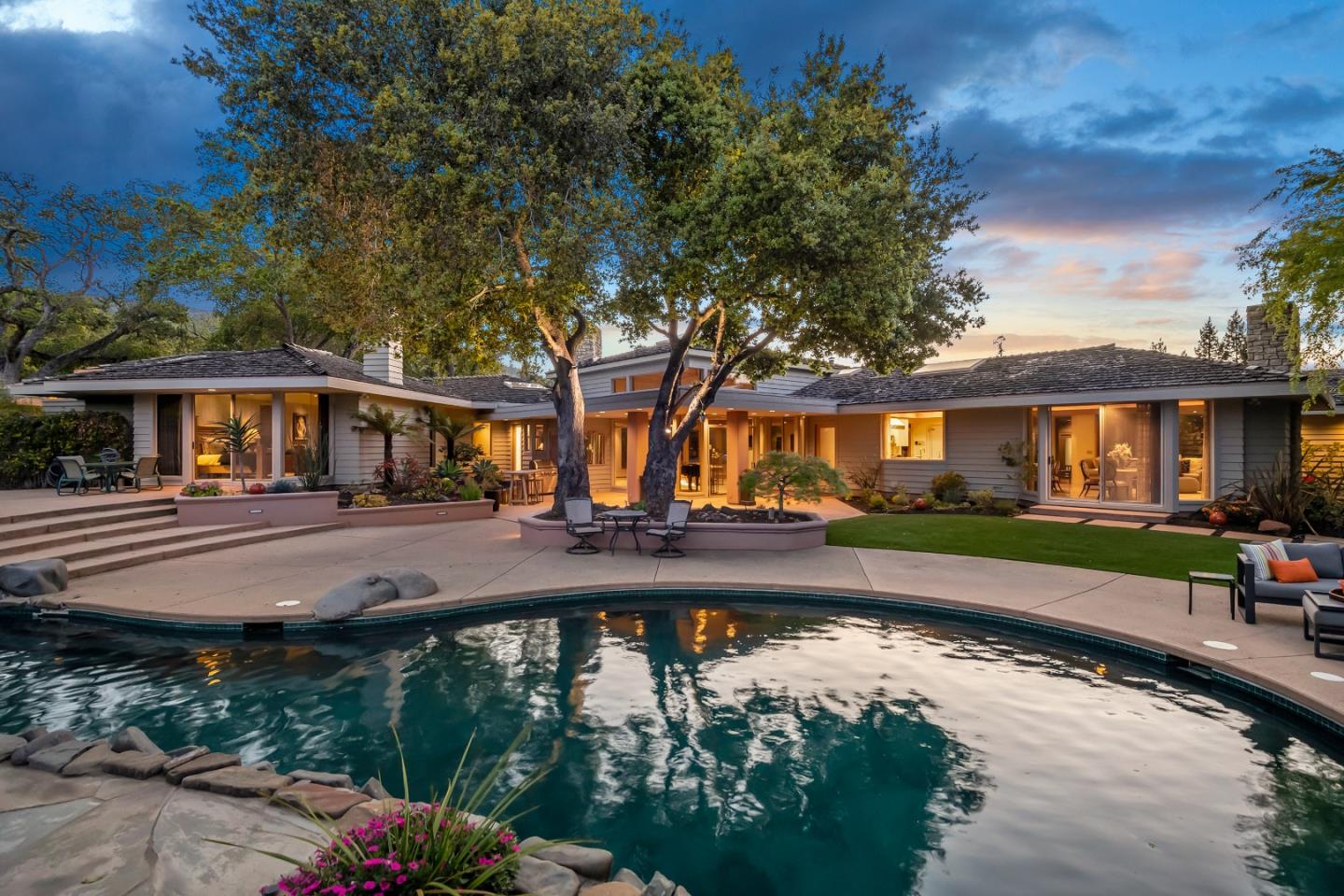 This exceptional custom estate is located on a prestigious gated street in one of Saratogas finest neighborhoods. The sprawling single-story home offers striking architectural details and an impressive open floor plan with soaring ceilings, generous rooms, custom millwork and an abundance of natural light from the floor-to-ceiling windows and doors throughout. The exquisite design and attention to detail create a sophisticated yet relaxed ambience in harmony with its natural surroundings, creating perfect indoor/outdoor living. The backyard is a private oasis featuring a sun-soaked pool and spa with waterfall surrounded by meticulously manicured gardens, mature trees, multiple entertainment areas and a 4-hole putting green. The property offers 5,013 sf of living space w/3bd/3.5ba in the main house & a 661 sf, 1bd/1ba guest house on a .97 usable ac. Close proximity to lively downtown Saratoga featuring fine & casual dining, boutique shopping, wineries & entertaining community events.