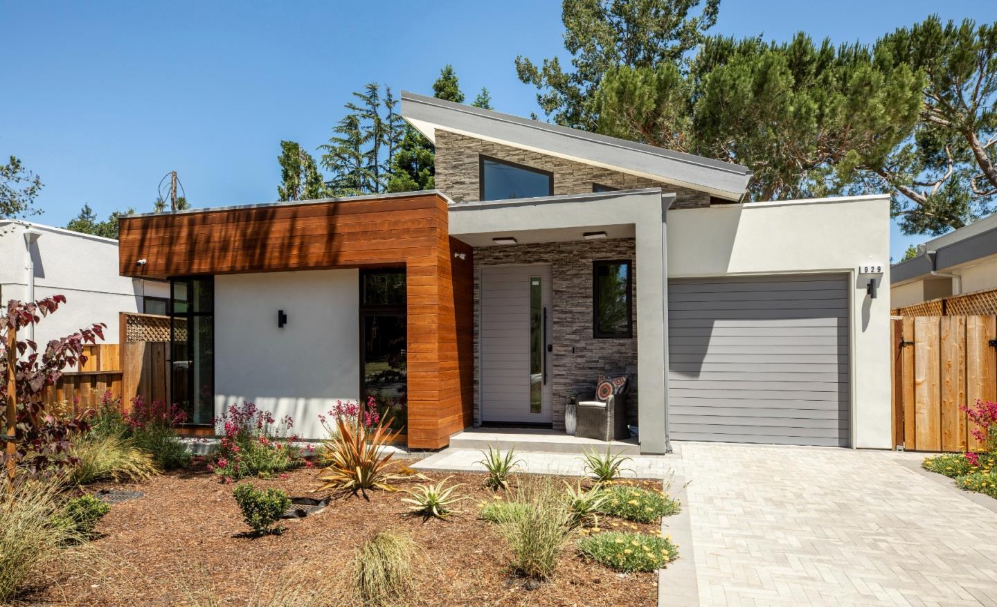 This sleek new build merges contemporary drama with modern comfort and convenience. The entry gallery opens to light-filled interiors with towering ceilings, skylights, and clerestory windows, creating a breezy, indoor-outdoor retreat at the heart of Los Altos. Gathering areas with an inset fireplace offer a folding Centor® glass wall connecting to the patio for versatile living and entertaining. The expansive waterfall island anchors a chefs kitchen fitted with Viatera® Calacatta Sol quartz countertops, custom cabinetry, and Thermador® smart appliances. Each level offers a laundry center and luxurious primary suite, and the lower level displays a flexible family room. Enjoy European white oak floors, surround sound, Da Vinci Marble® and heated floors for bathrooms, and smart features throughout. This home is nestled along an impasse street lined with recent builds, showcasing the high desirability of this setting.